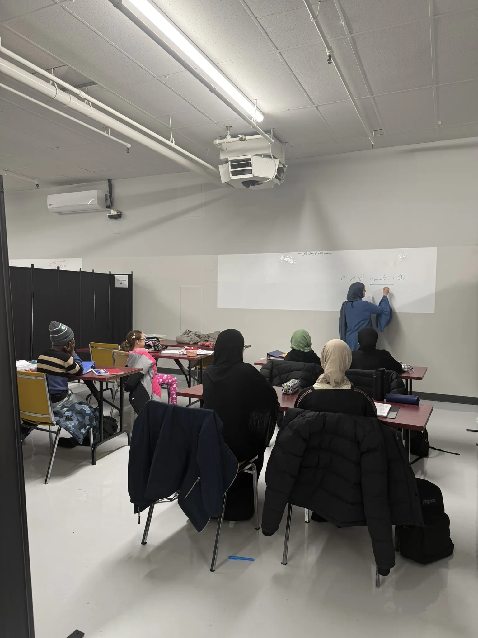 Une classe d'adultes en cours, face au tableau.